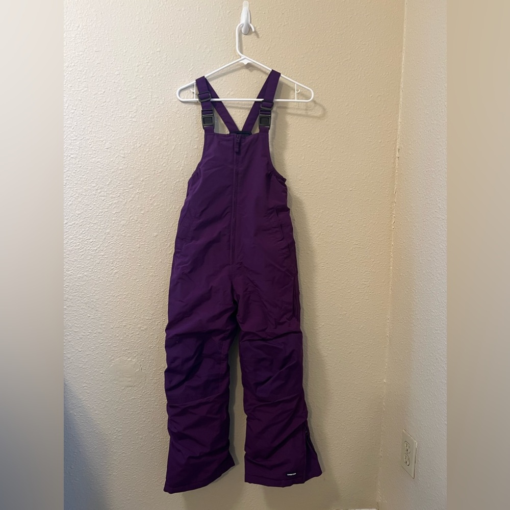 Insulated bib snow pants with reinforced knees and seat. Waterproof Windproof